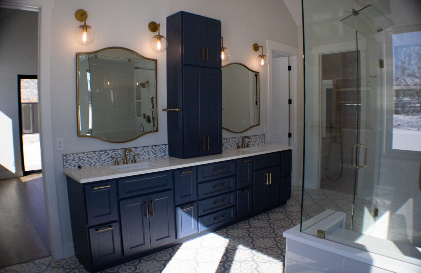 a bathroom with blue counters, two sinks, and mirrors