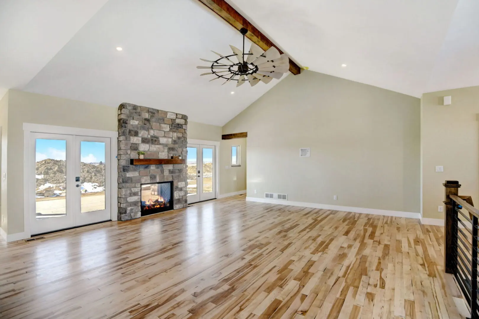 Empty room with fire place and ceiling fan