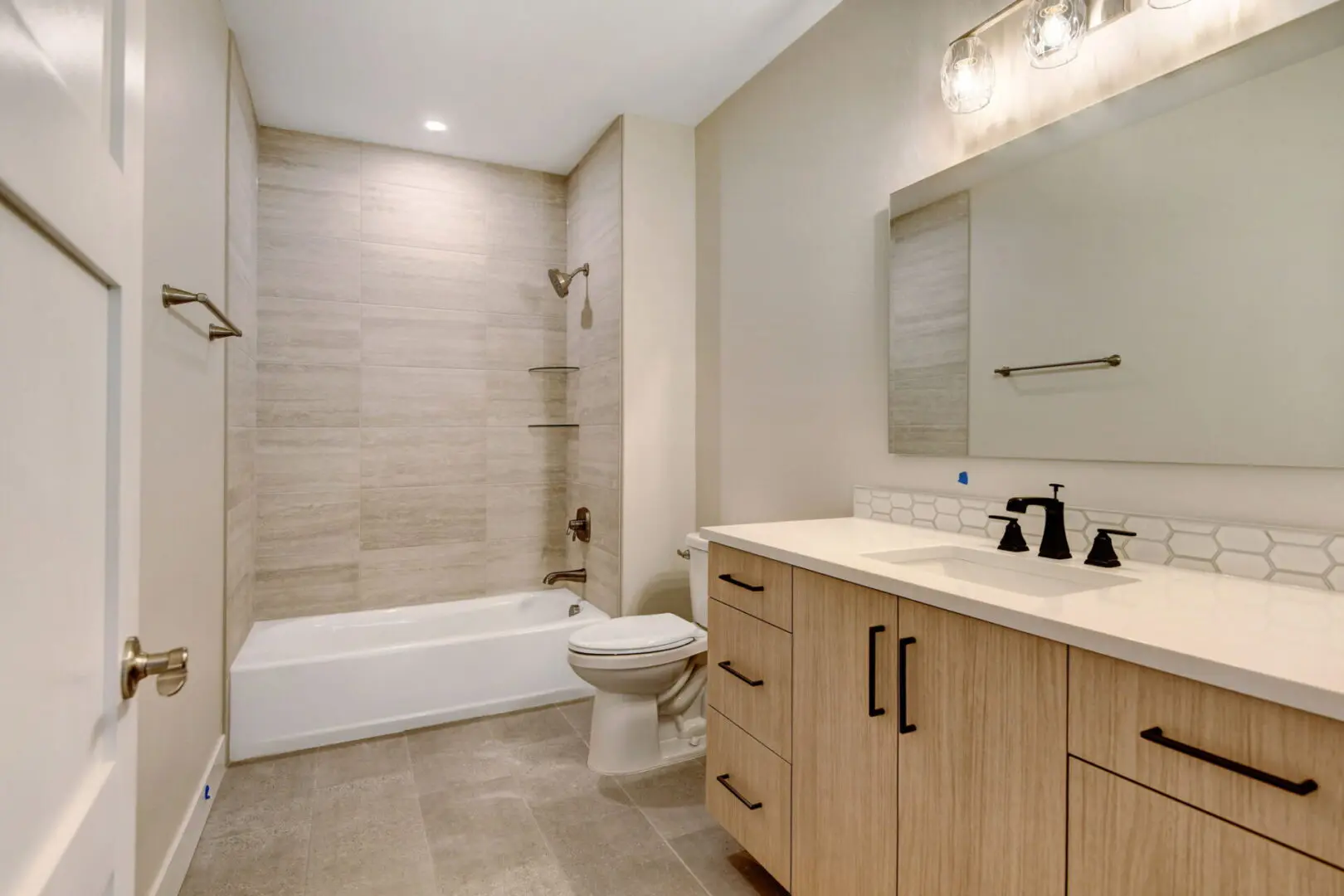 A modern bathroom with sink and bathtub